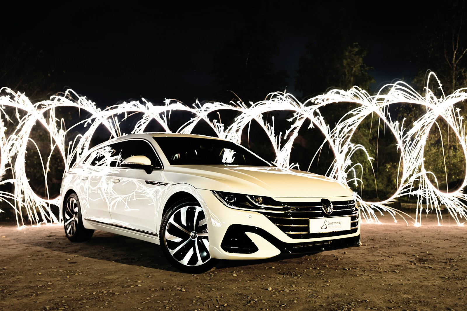 buying a new car parked on a dirt road with fireworks in the background